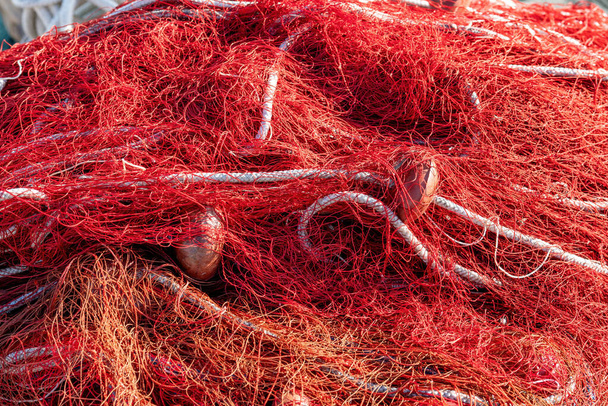https://cdn.create.vista.com/api/media/small/468644002/stock-photo-red-fishing-nets-floats-ropes-still-life-shot-perfect-image