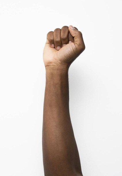 black person holding fist up. Resolution and high quality beautiful photo - Фото, изображение