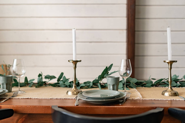 Close-up celebratory table, empty glasses set in home kitchen, family holidays celebration  - Photo, Image