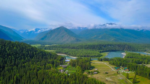 Aerial view of the Kucherla river valley overlooking the farm, forest and mountain ridge, Altai photo by drone - 写真・画像