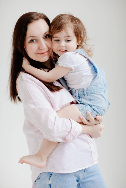 beautiful happy family. Mom and daughter cuddling - Foto, Imagen
