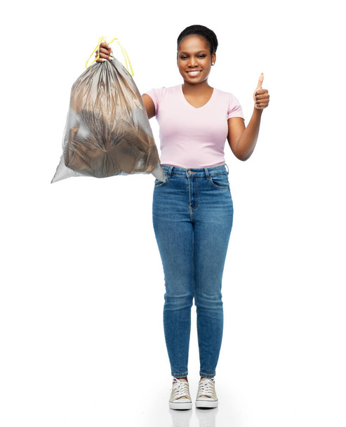 smiling woman holding plastic trash bag with waste - Foto, Bild