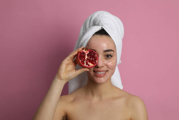 Woman with pomegranate face mask and fresh fruit on pink background - Fotó, kép
