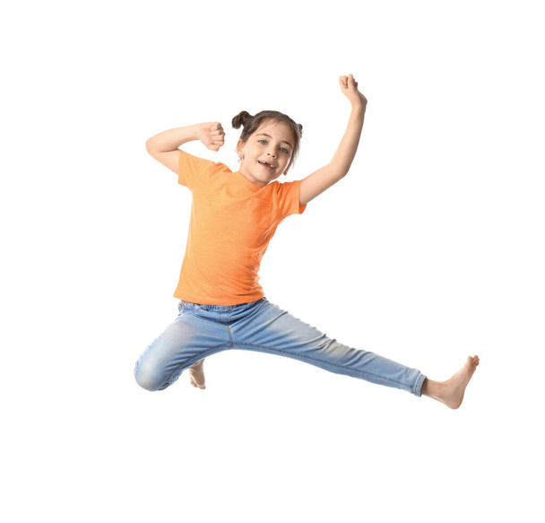 Cute little girl jumping on white background - 写真・画像
