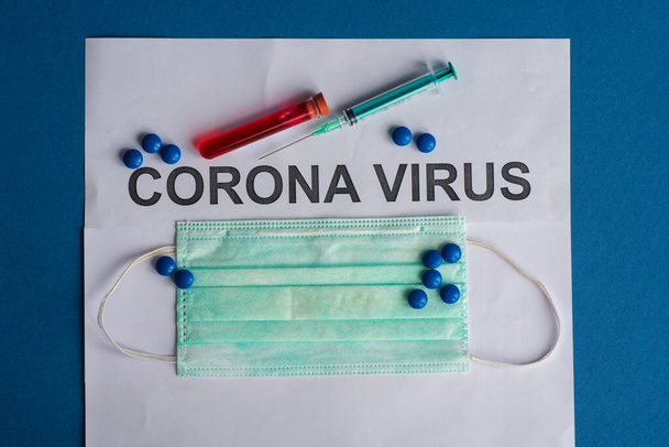 Tablet pills with syringe or injection, thermometer and Test tube containing a blood sample for testing to the presence of coronavirus / COVID-19 with board of Coron Vrus. - Fotoğraf, Görsel