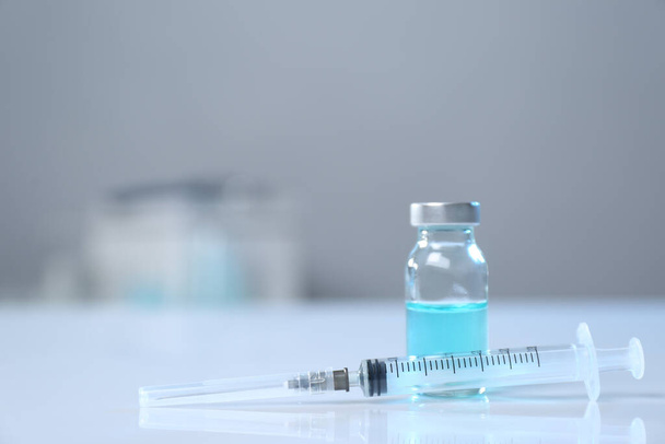 Syringe and vial on white table. Space for text - Fotografie, Obrázek