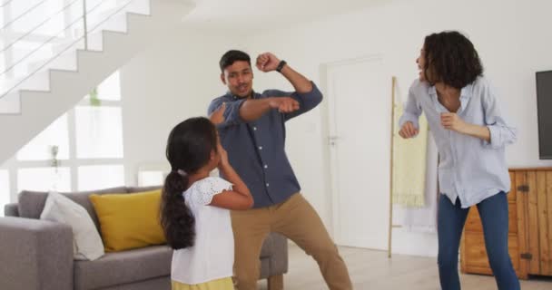 Happy hispanic family with daughter dancing having fun in living room. at home in isolation during quarantine lockdown. - Filmmaterial, Video