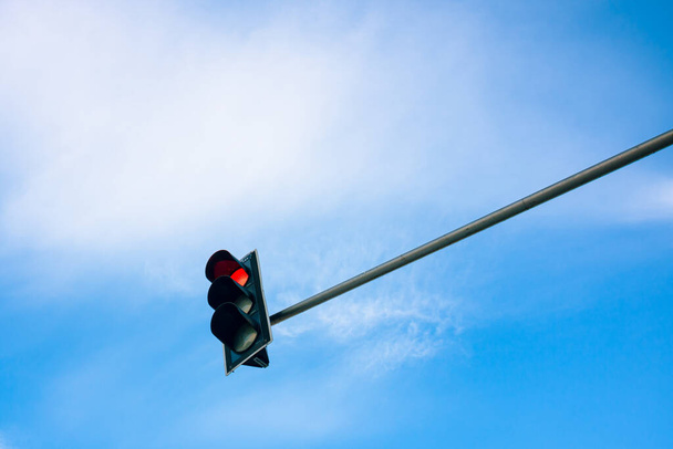 Red Traffic light on the cloudy sky background. Stop sign. Traffic light background photo. Transportation background. Limitation theme.  - 写真・画像