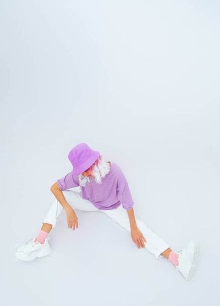 Girl Model in trendy summer look and  accessories posing in white studio.  Bucket hat. Street style. Urban. - Photo, Image