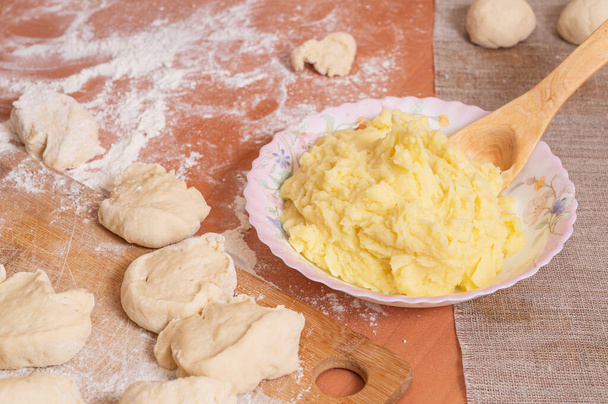 The mashed potatoes are prepared for baking homemade buns. - 写真・画像