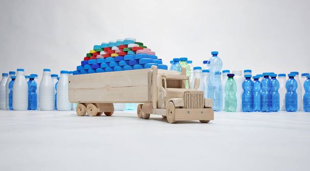 Drewniana ciężarówka przewozi plastikowe nakrętki, plastikowe butelki w tle. Plastikowe miasto. Koncepcja bez plastiku. Koncepcja transportu o niskiej emisji CO2. - Zdjęcie, obraz