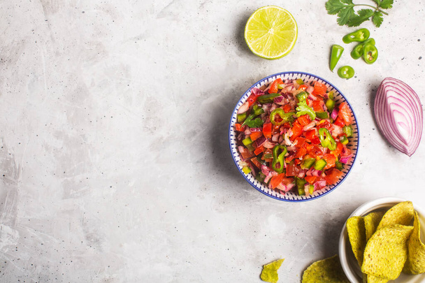 Fresh bowl of homemade salsa pico de gallo, mexican cuisine with copy space - Foto, afbeelding