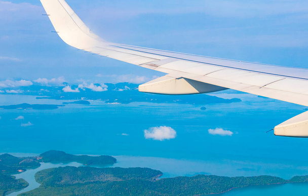 Flying over Thailand panoramic view of the beautiful islands coastal beaches turquoise waters and clouds. - 写真・画像