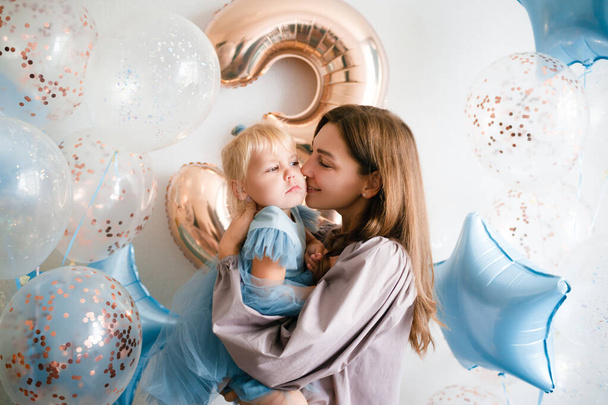 Mother and daughter celebrate their birthday in beauty dresses with balloons.  - Φωτογραφία, εικόνα