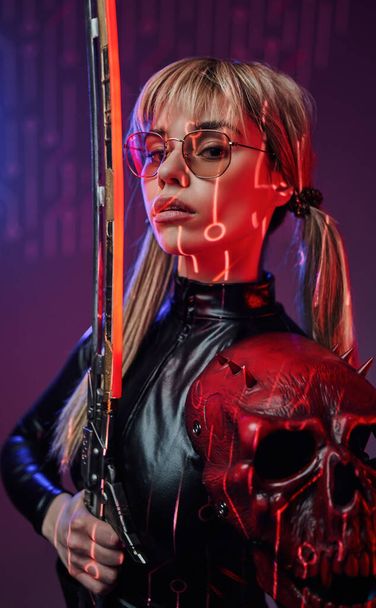 Portrait of young woman with sunglasses and sword - Photo, Image