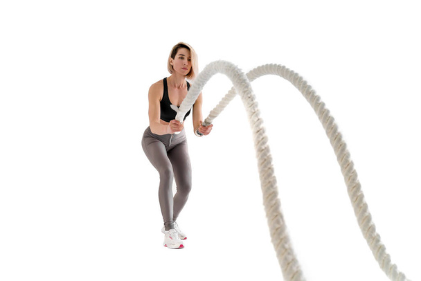 Woman doing exercises with battle rope. - Fotó, kép