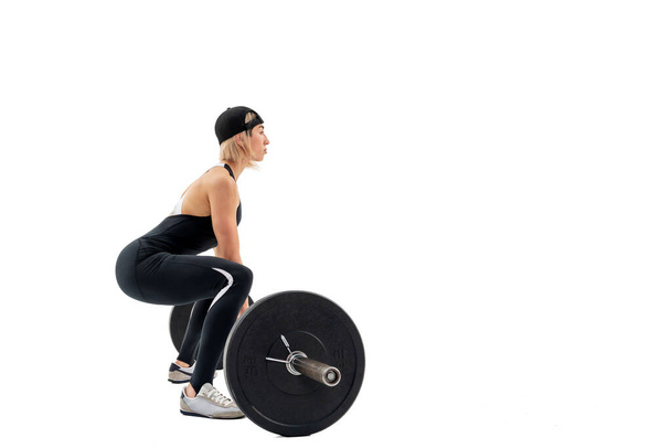 Young woman doing deadlift with a barbell isolated on white - Fotoğraf, Görsel