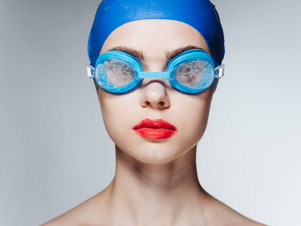 Woman in glasses and in a blue swimming cap athlete athletics model naked shoulders - Photo, Image