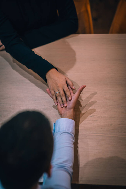 Vista superior de um casal feliz ter um encontro romântico em um restaurante usando um anel de proposta - Foto, Imagem