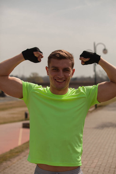 Strong and attractive male is flexing after the training - Foto, Imagem