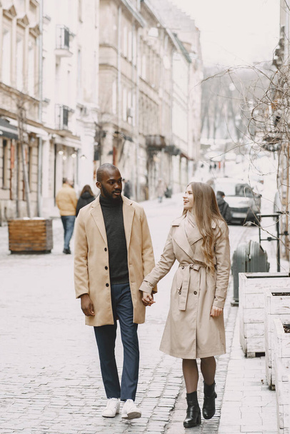 Mixed couple spenting time together in a spring city - Foto, Imagem