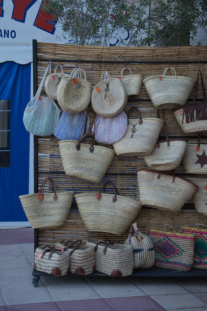 Sale of wicker baskets on the beach. Set of beach baskets for the summer. Campello, Alicante, Spain - Photo, Image
