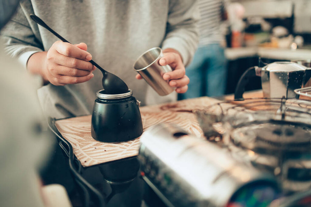 Barista measure coffee powder and brewing black moka coffee using moka coffee maker. - Fotografie, Obrázek