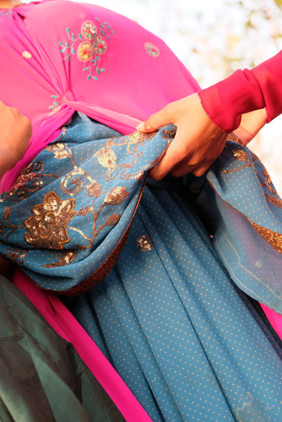 A closeup shot of a female hand holding colorful fabrics - Фото, изображение