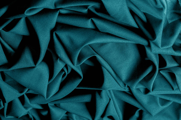 Textured, background, pattern, turquoise fabric. This is an unusual fabric that has an elegant appearance with a rich and coarse texture. It is tightly knit with designs built into the fabric itself - Foto, afbeelding