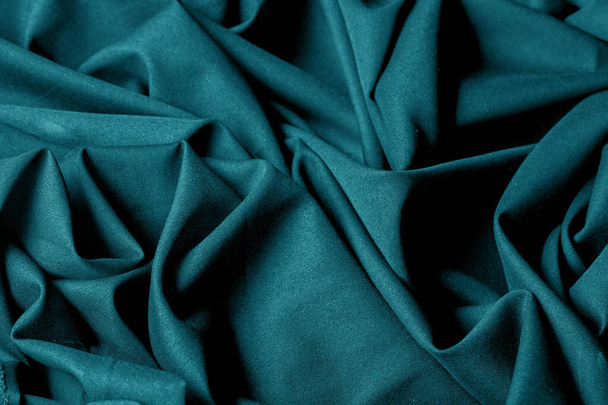 Textured, background, pattern, turquoise fabric. This is an unusual fabric that has an elegant appearance with a rich and coarse texture. It is tightly knit with designs built into the fabric itself - Photo, Image
