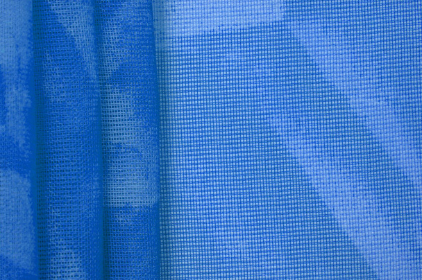 Modrá hedvábná tkanina, abstraktní pozadí z černého hedvábí. Textilní textura s drapérií. Rozumím. Designový prvek. Valentýn. Vzor textury, ozdoba, pozadí - Fotografie, Obrázek