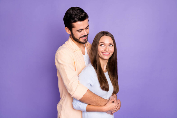 Photo of brown haired man and woman hug look each other wear casual outfits isolated on purple color background - Foto, Imagem