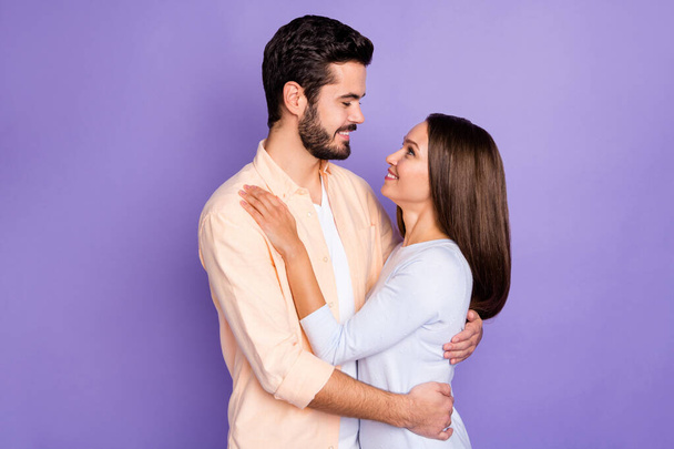 Photo of romantic young couple hug look each other dream date day wear orange shirt blue sweater isolated on violet color background - Valokuva, kuva