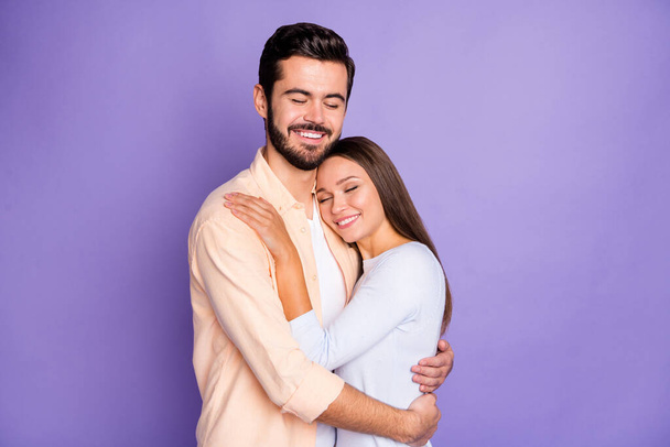 Photo of happy man and woman embrace good mood closed eyes nice smile isolated on violet color background - Fotografie, Obrázek