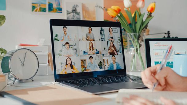 Young asia female employee listen leader on video call with diverse multiracial colleagues on online with laptop at home. Distance learning. Girl student learn online at house, Online meeting concept. - Foto, immagini