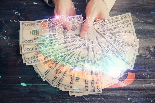 Multi exposure of technology drawing hologram and us dollars bills and man hands. Data concept - Φωτογραφία, εικόνα