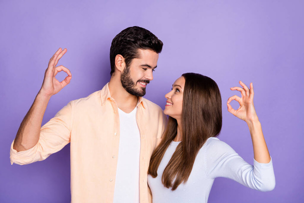 Photo of trendy romantic brunette couple show ok sign look each other harmony isolated on purple color background - Fotografie, Obrázek