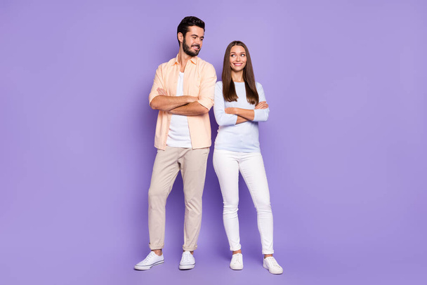 Full size photo of happy man and woman couple look each other folded arms good mood harmony isolated on purple color background - Photo, image