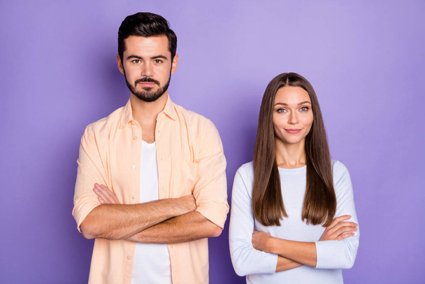 Photo of confident serious married man and woman folded arms wear blue sweater orange shirt isolated on violet color background - Photo, image