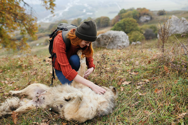woman hiker outdoors playing with dog friendship fun - Photo, image