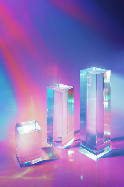 three clear glass rectangle prism podiums on holographic colored background  - Foto, afbeelding