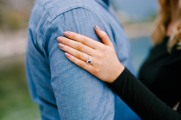 Girl put her hand with a ring on the mans shoulder. Close up - Fotografie, Obrázek