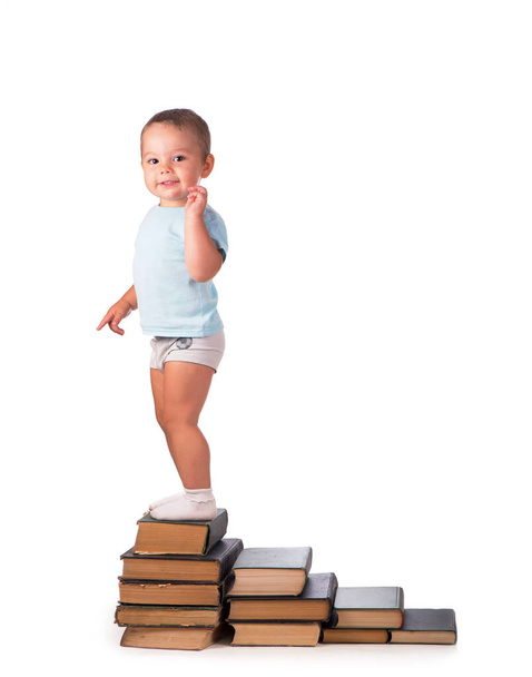 Boy with books for an education portrait - isolated over a white background - Фото, изображение