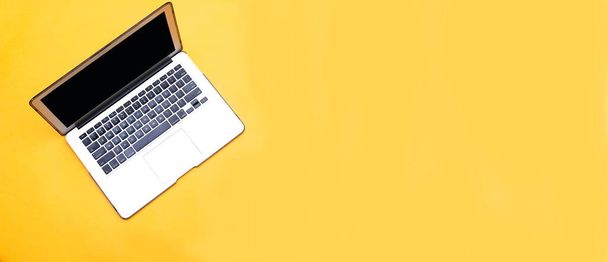 Front View of Modern Laptop isolated on yellow background - Foto, afbeelding