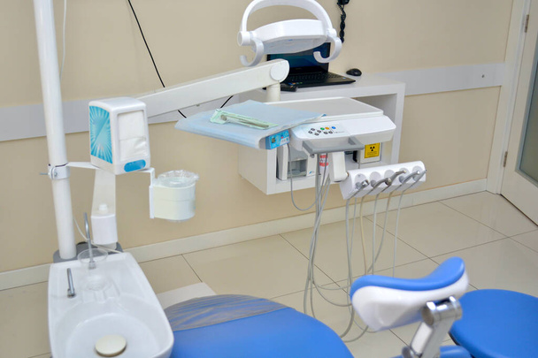 An ultra modern dentist's practice and clinic. The treatment room uses dental equipment and instruments harnessing up to date technology. The room is bright, light and hygienically clean. - Photo, Image