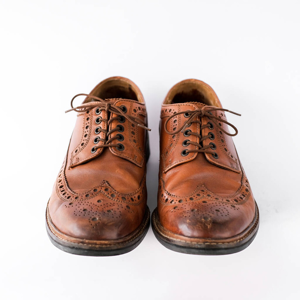 brown men's brogues on a white background close-up. classic men's shoes. mockup - Фото, изображение