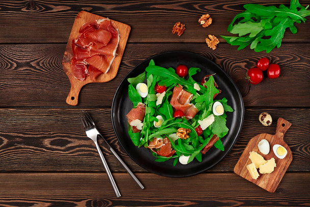 Salad, arugula leaves, with Parma prosciutto, cherry, quail eggs, healthy food, top view, horizontal, no people, - Fotó, kép