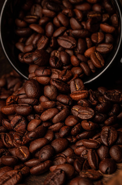 Roasted coffee beans on the old dark wooden background for wallpaper or decor. - Zdjęcie, obraz