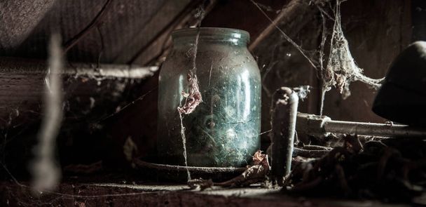 dusty glass with cobwebs in an old abandoned house - Фото, изображение