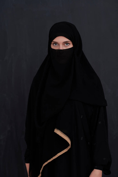 Portrait of muslim woman wearing niqab and traditional arabic clothes or abaya. Arab woman representing modern arabic lifestyle, islamic fashion and Ramadan kareem concept - Valokuva, kuva